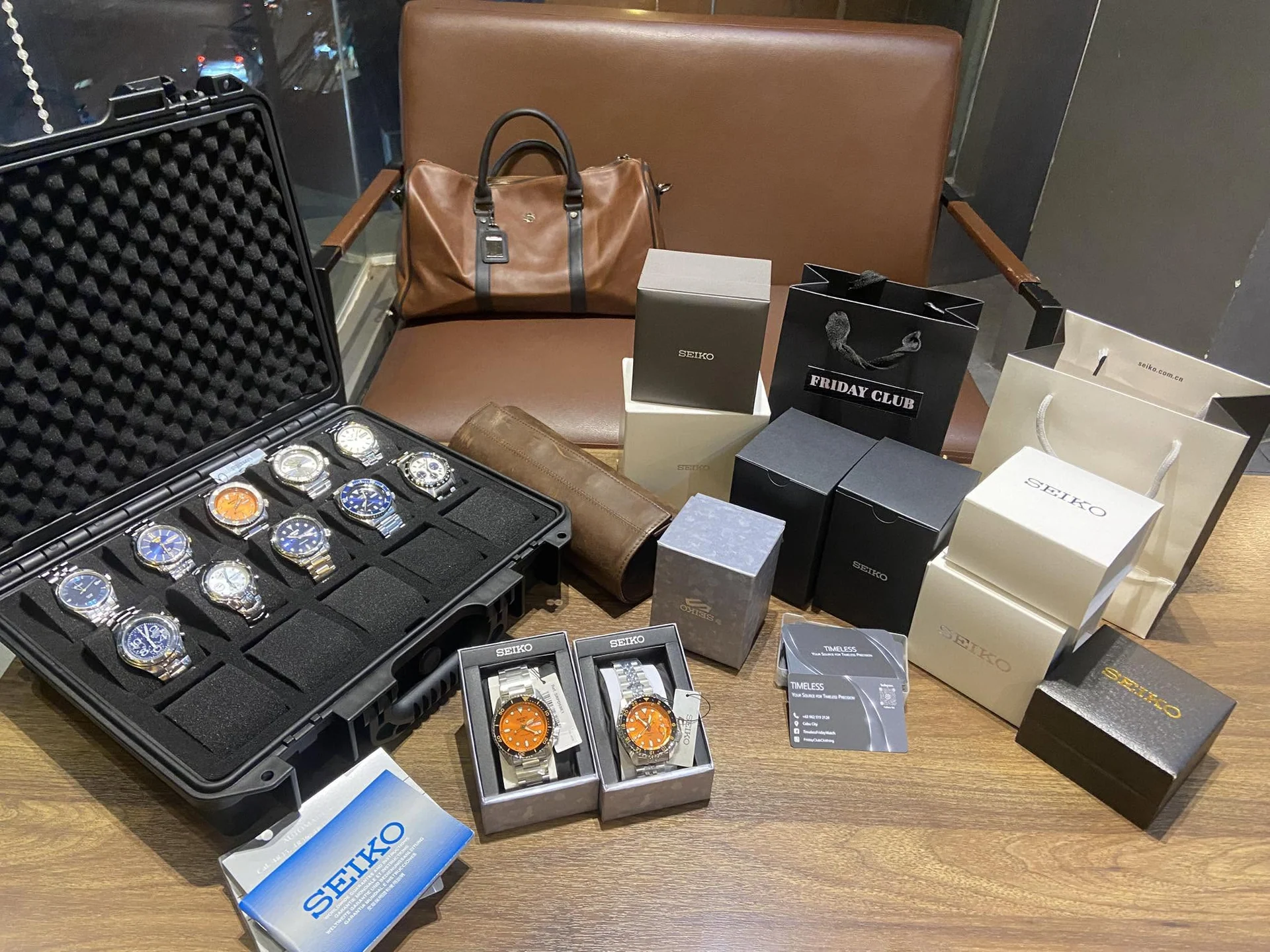 Timeless Friday watch cases and boxed automatic watches arranged on a presentation table